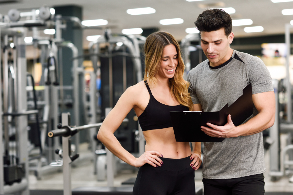 Gym coach guiding a member through a workout